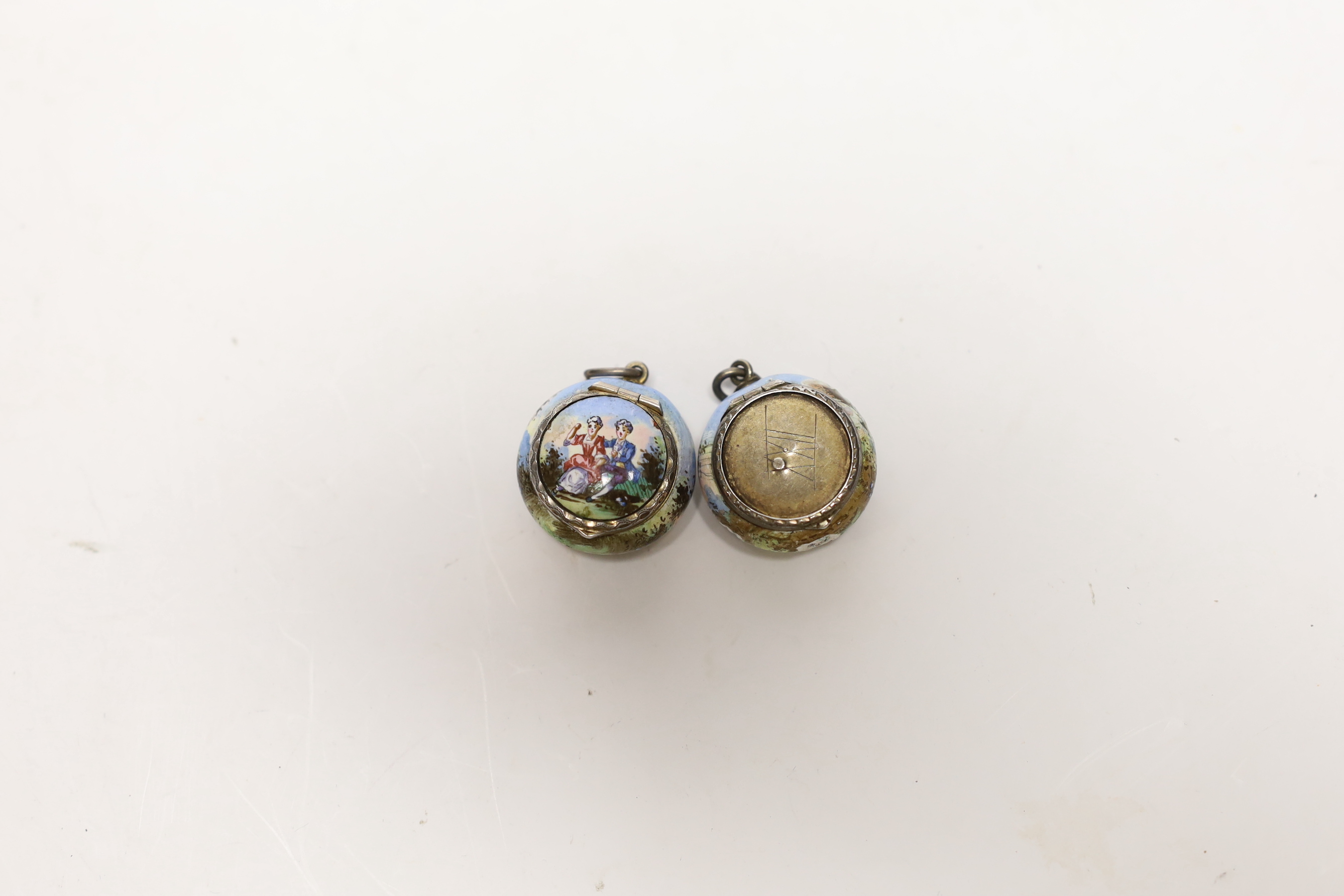 Two 19th century Viennese gilt white metal and enamel circular vinaigrettes, maker SG, enamel missing from one cover, diameter 22mm.